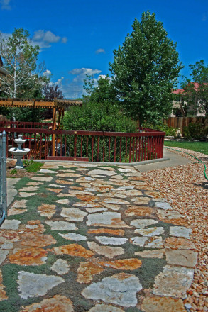 A very nice do-it-yourself patio with some green to soften the aesthetics.