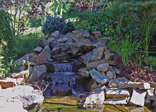 Design & Installation: Landscape Technology, Vail, CO. Description: Specimen Stone Boulder with Sienna Buff slabs and Moss Rock.