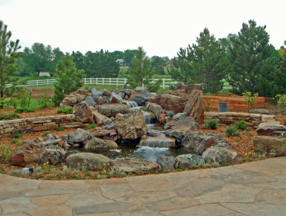 Design and Installation: Ron Koch Landscaping, Littleton, CO. Description: Siloam Canyon Stone and Specimen Stone in and around water feature, Siloam Sienna Buff and Grey Wall Stone for wall.
