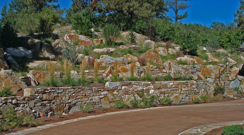 Design and Installation: Classic Gardens, Colorado Springs, CO. Description: Siloam Cinnamon Shadow Quarry Boulders, Landscape Accents. Walls: Combination Cinnamon Shadow Quarry Boulders and Siloam Wall Stone.